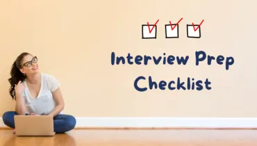 girl sitting on the floor with computer looking up at a checklist