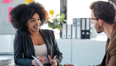 Two people are doing an nformational interview. This blog by jobtrees.com is all about informational interviews and networking. Find out what an informational interview is and how to prepare for one