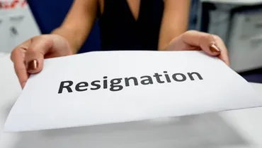 woman handing over her 2 week noticed titled resignation letter