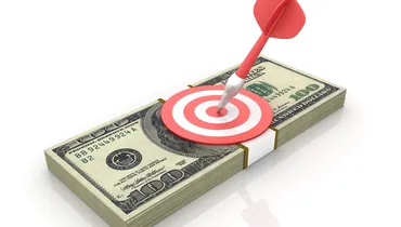 bullseye on a stack of $100 bills. strategies to earn more in your career blog